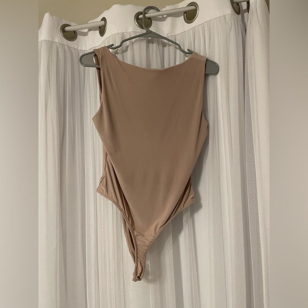 Squareneck bodysuit with button closure.
